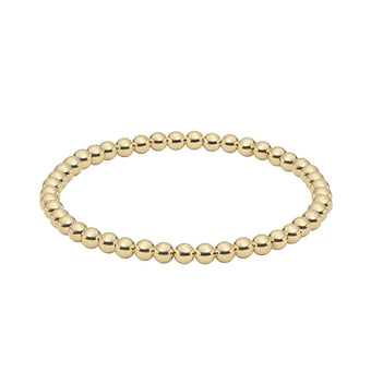 Minimalist gold stretch bracelet with polished round beads, perfect for everyday wear or stacking with layered accessories.