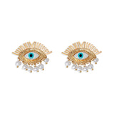 Gold eye-shaped earrings with blue evil eye centers, featuring cascading pearl drop details for a bold and protective statement look.