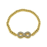 gold infinity bracelet on white background