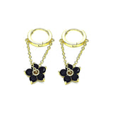 gold dangle flower earrings black flower gemstones on white background